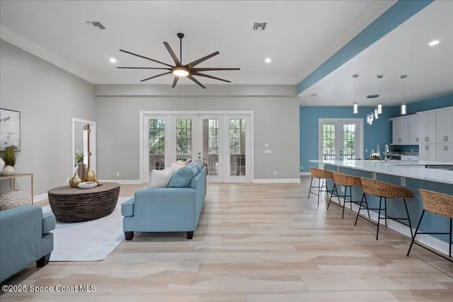 a dining hall with stainless steel appliances a dining table and chairs with wooden floor