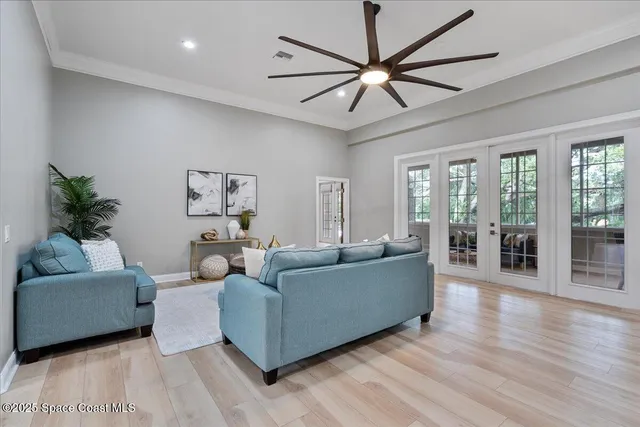 a kitchen with stainless steel appliances a dining table chairs microwave and sink