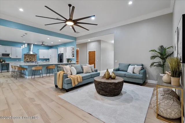 a dining room with furniture a chandelier and wooden floor
