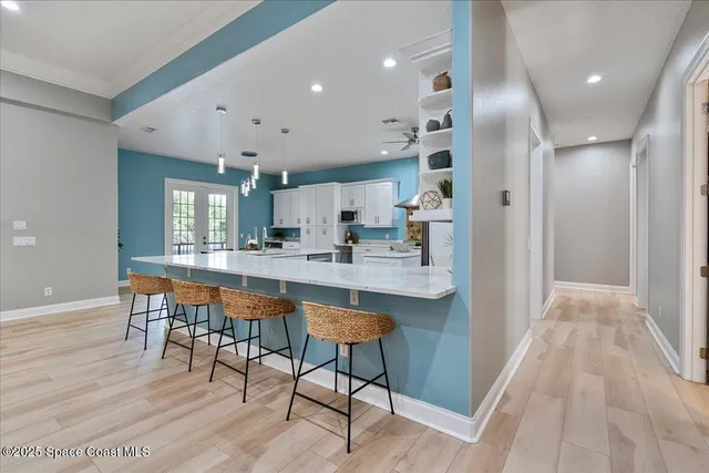 a kitchen with a stove a refrigerator and a stove top oven
