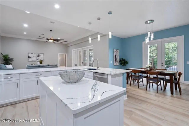 a spacious bathroom with a double vanity sink mirror and shower