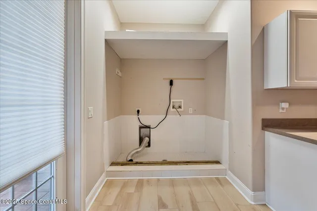 a spacious bedroom with a bed and a chandelier
