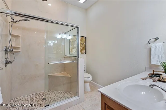 a bedroom with a bed chandelier and a window