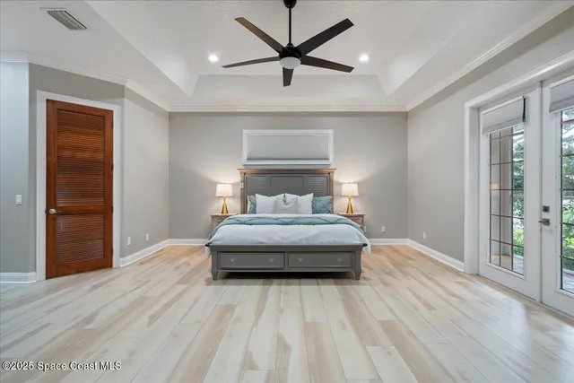 a bedroom with bed and wooden floor