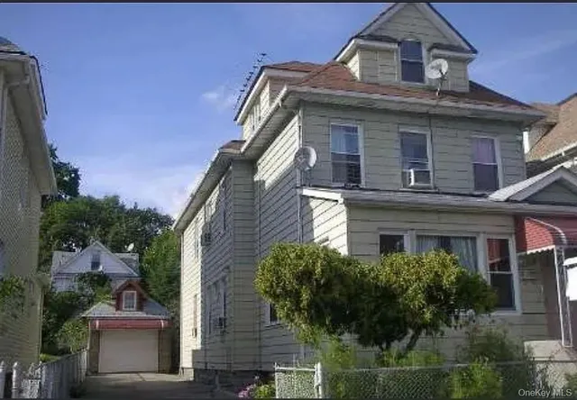 front view of a house with a small yard