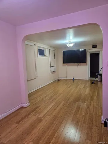 a living room with a flat screen tv and gym equipment