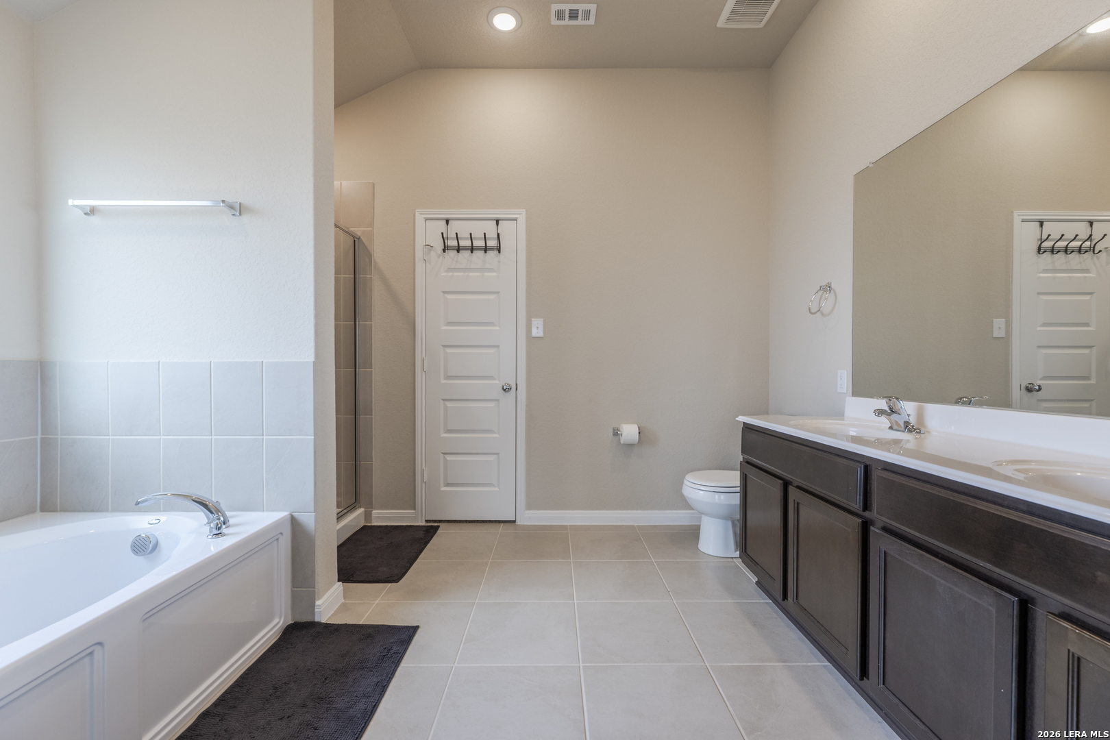 3035 Selhurst Street Converse, TX 78109 - Photo 11 of 18 a bathroom with a tub sink and mirror