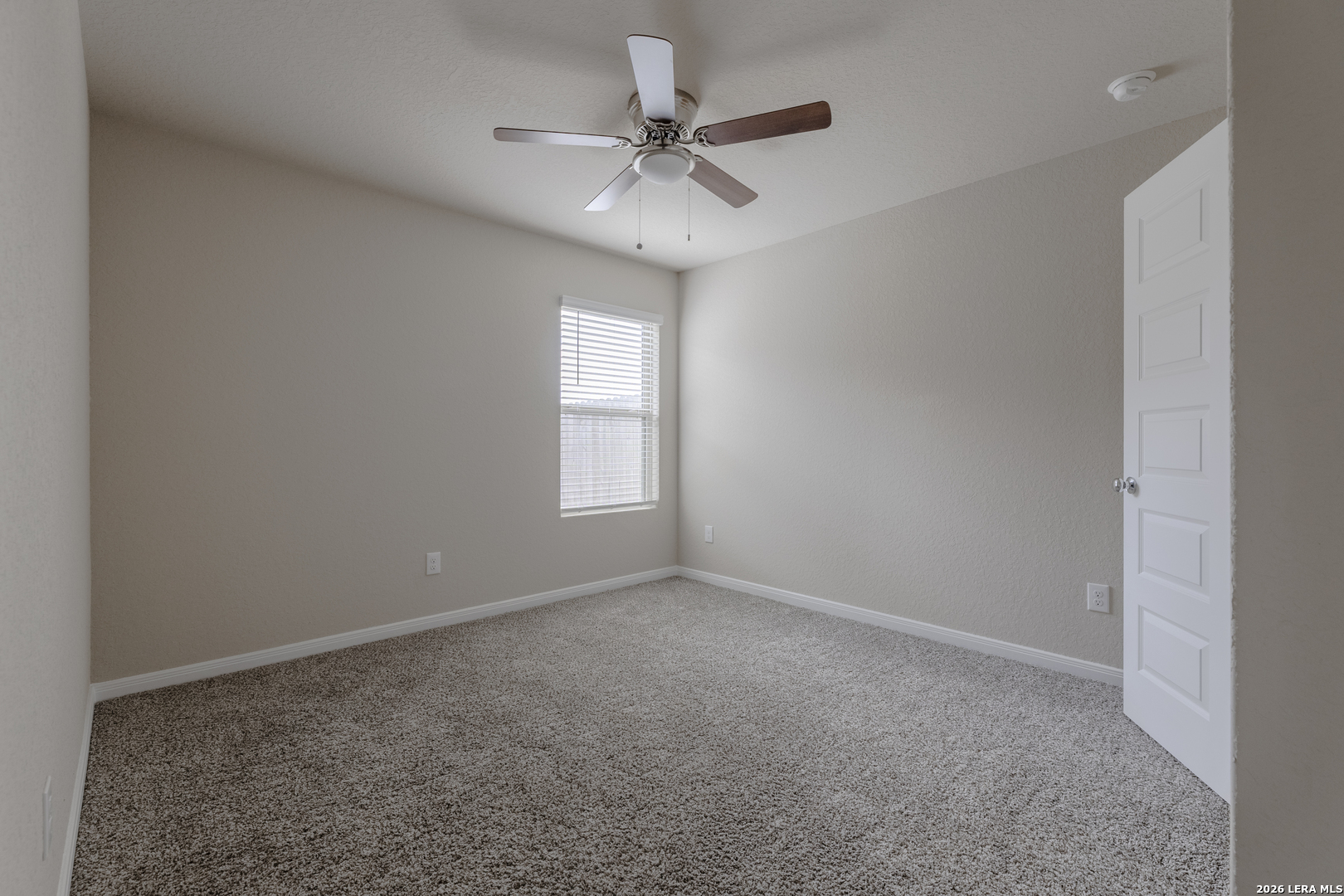 3035 Selhurst Street Converse, TX 78109 - Photo 13 of 18 an empty room with a window and a fan