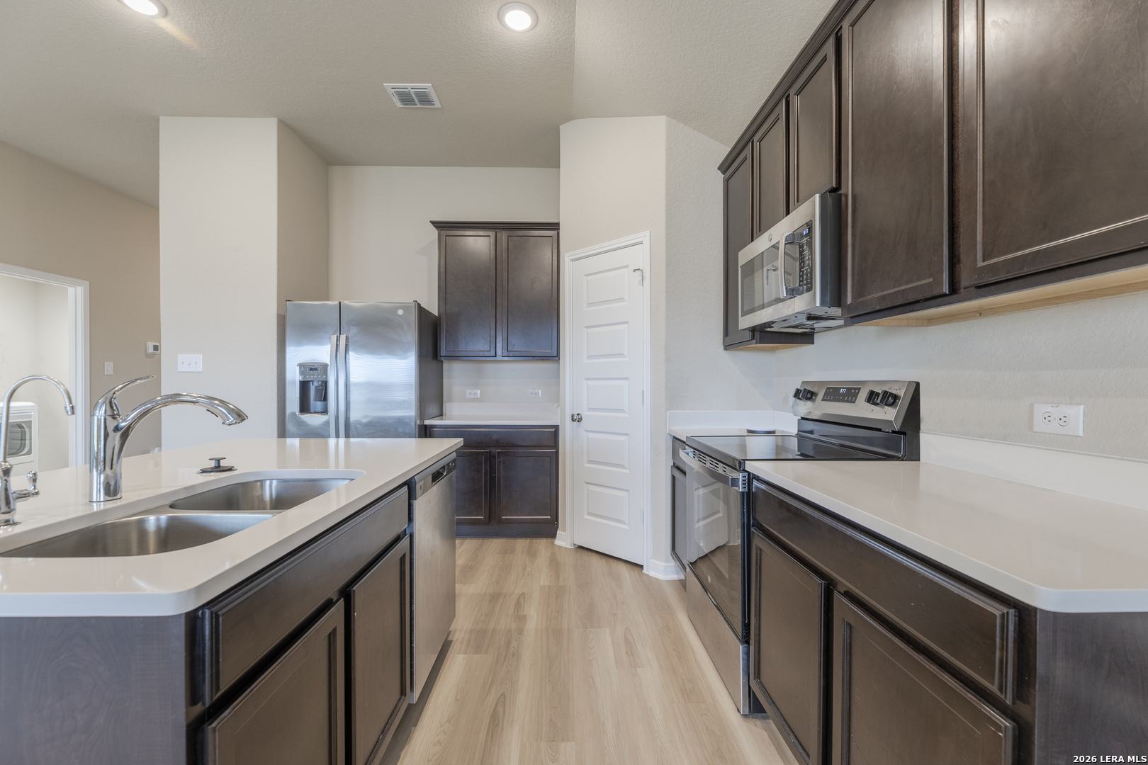 3035 Selhurst Street Converse, TX 78109 - Photo 4 of 18 a kitchen with stainless steel appliances granite countertop a sink stove and refrigerator