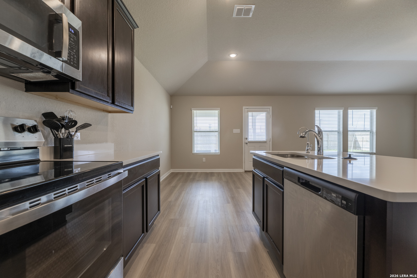 3035 Selhurst Street Converse, TX 78109 - Photo 5 of 18 a kitchen with stainless steel appliances a sink a stove cabinets and wooden floor