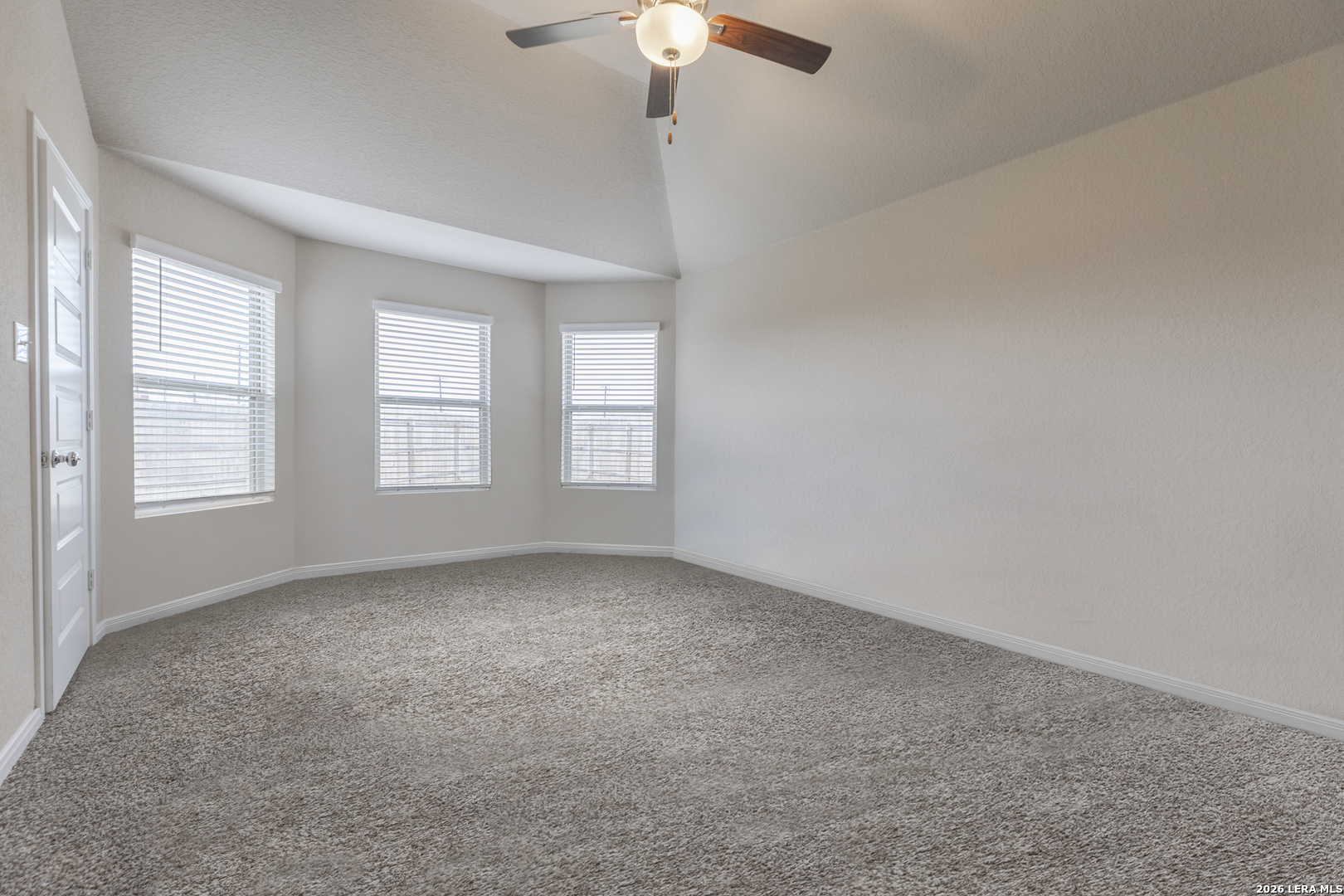 3035 Selhurst Street Converse, TX 78109 - Photo 8 of 18 an empty room with windows and chandelier fan