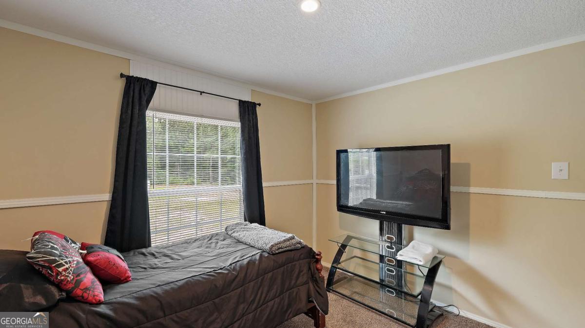64 Sierra Road Jesup, GA 31545 - Photo 14 of 22 a bedroom with furniture and a window