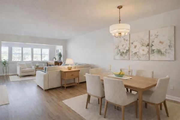 a view of a dining room with furniture wooden floor and a chandelier