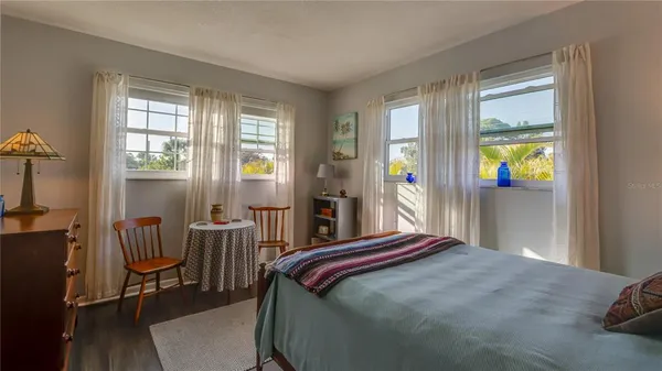 a bedroom with a bed and a large window
