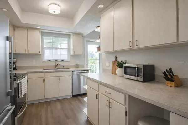 a kitchen with sink cabinets and window
