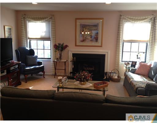 4402 Stonehedge Road Edison, NJ 08820 - Photo 2 of 25 a living room with furniture and a fireplace