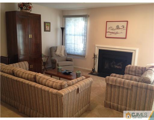 4402 Stonehedge Road Edison, NJ 08820 - Photo 11 of 25 a living room with furniture and a fireplace