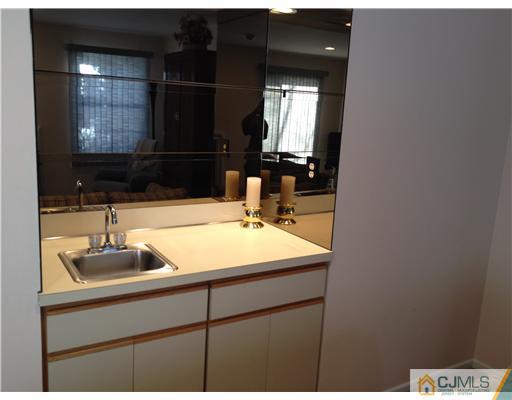 4402 Stonehedge Road Edison, NJ 08820 - Photo 13 of 25 a bathroom with a sink and a mirror