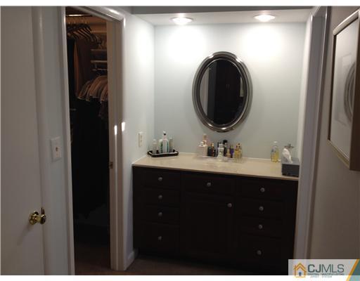 4402 Stonehedge Road Edison, NJ 08820 - Photo 18 of 25 a bathroom with a sink and a mirror