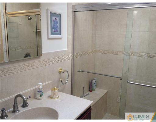 4402 Stonehedge Road Edison, NJ 08820 - Photo 19 of 25 a bathroom with a sink and a mirror