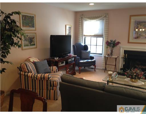 4402 Stonehedge Road Edison, NJ 08820 - Photo 3 of 25 a living room with furniture and a flat screen tv