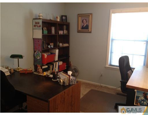 4402 Stonehedge Road Edison, NJ 08820 - Photo 22 of 25 a room with furniture and a book shelf