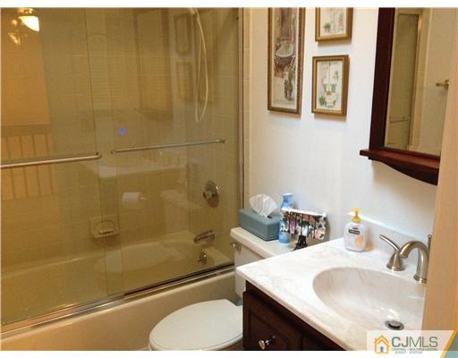 4402 Stonehedge Road Edison, NJ 08820 - Photo 23 of 25 a bathroom with a sink and a mirror
