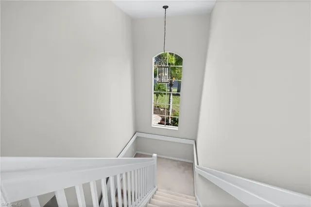 a bedroom with furniture and a chandelier