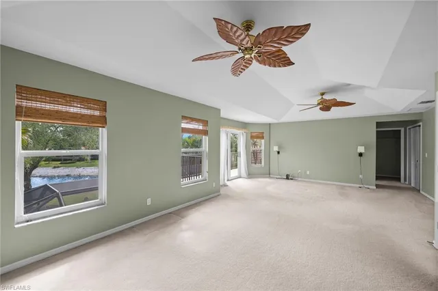 a bed room with a bed a television and a large window