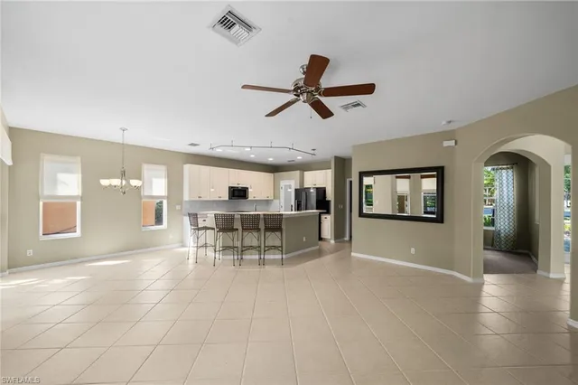 a view of a livingroom with furniture and a ceiling fan
