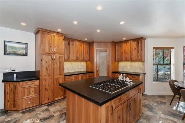a kitchen with stainless steel appliances granite countertop a stove a refrigerator and a microwave