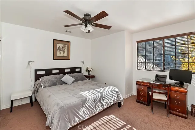 a bedroom with bed painting on the wall and a window