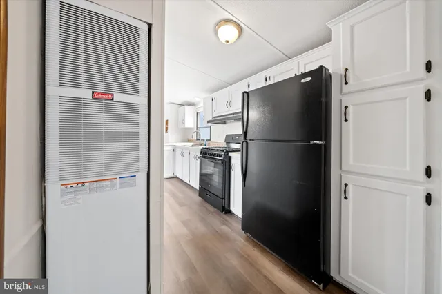 a view of a kitchen with a refrigerator and a refrigerator