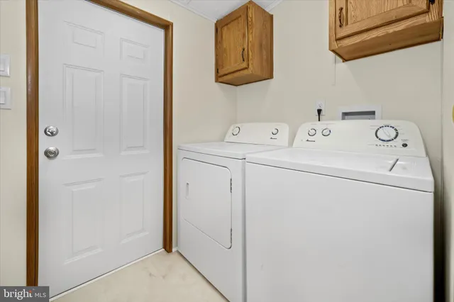 a view of storage and utility room with washer and dryer