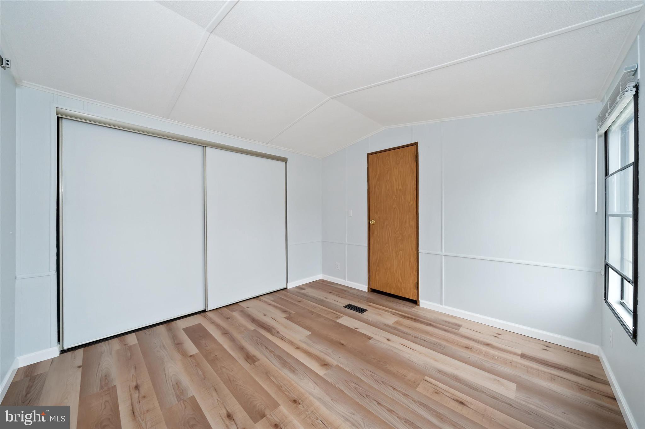 416 Ranee Loop, Unit 96 Bear, DE 19701 - Photo 18 of 31 a view of empty room with wooden floor