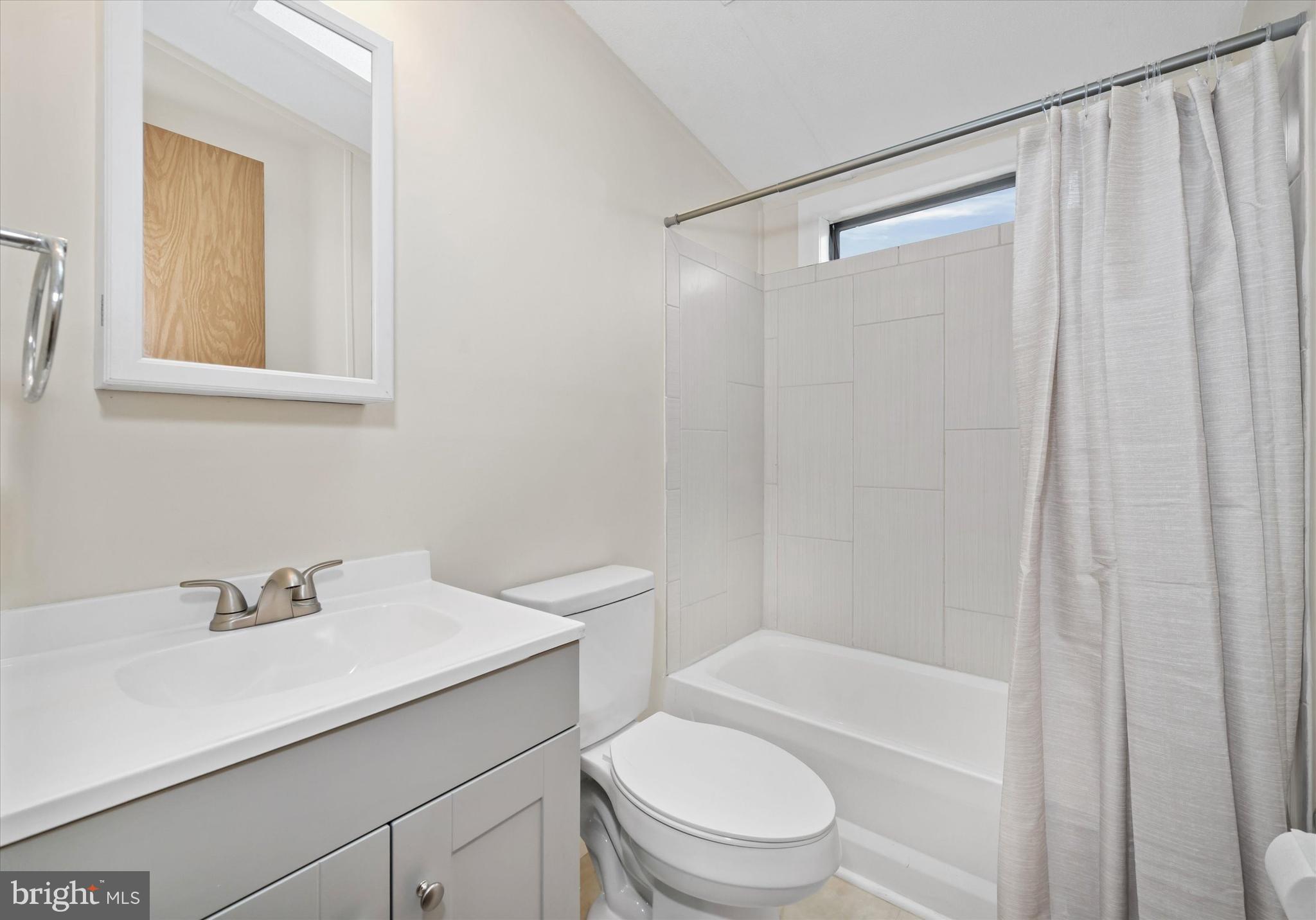 416 Ranee Loop, Unit 96 Bear, DE 19701 - Photo 24 of 31 a bathroom with a sink a mirror a toilet and shower