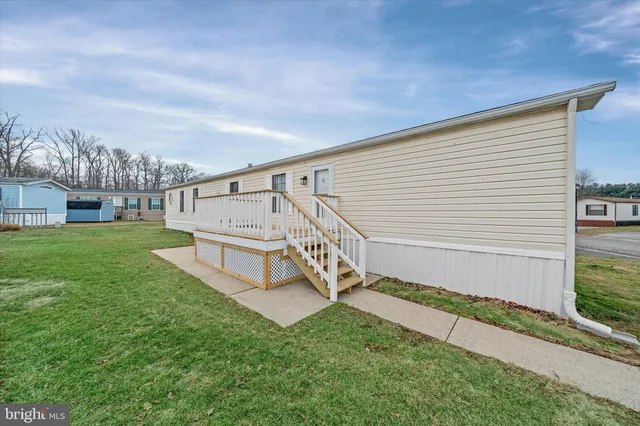 a view of house with yard and staircase