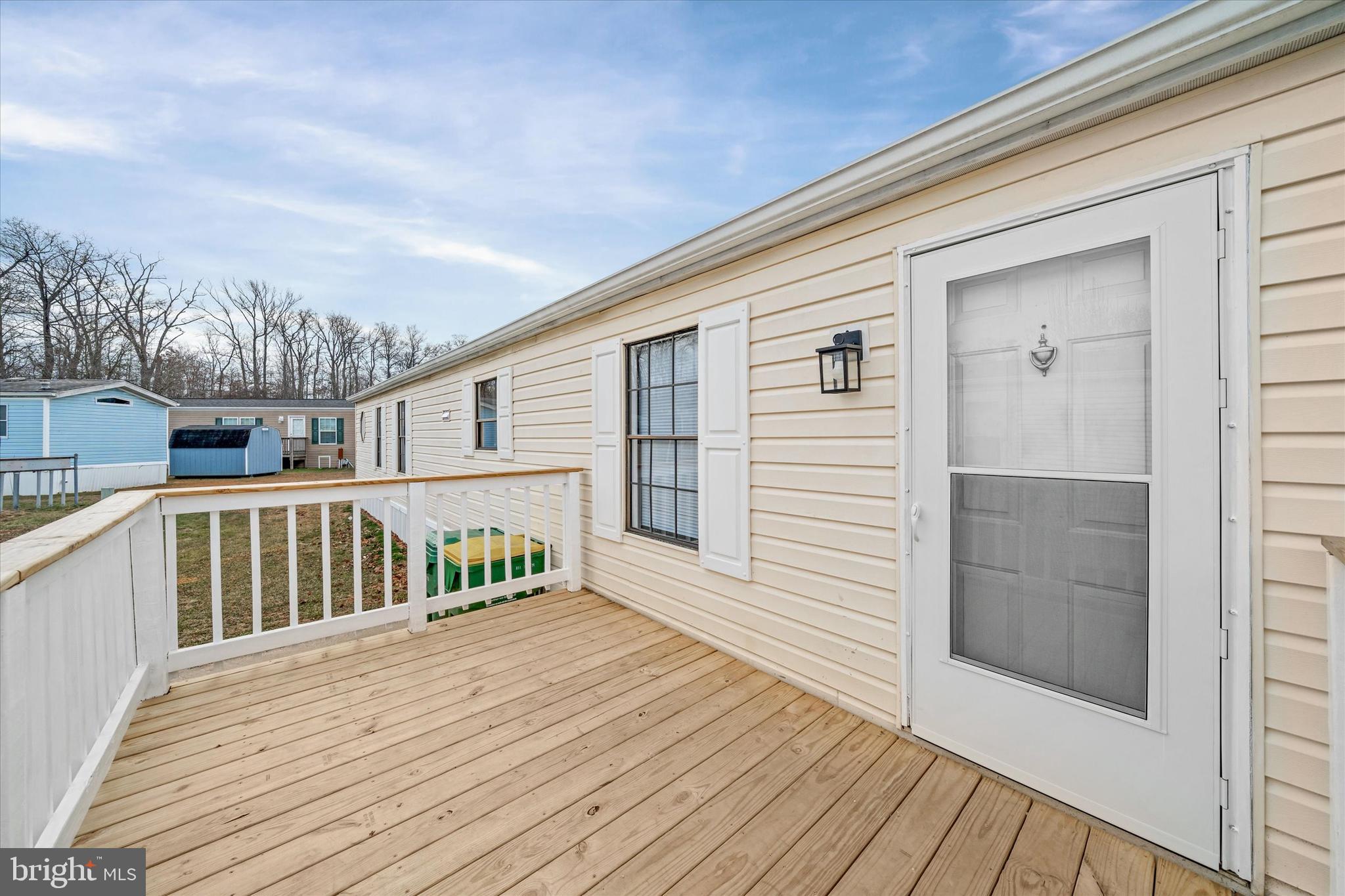 416 Ranee Loop, Unit 96 Bear, DE 19701 - Photo 3 of 31 a porch with wooden floor in front of it