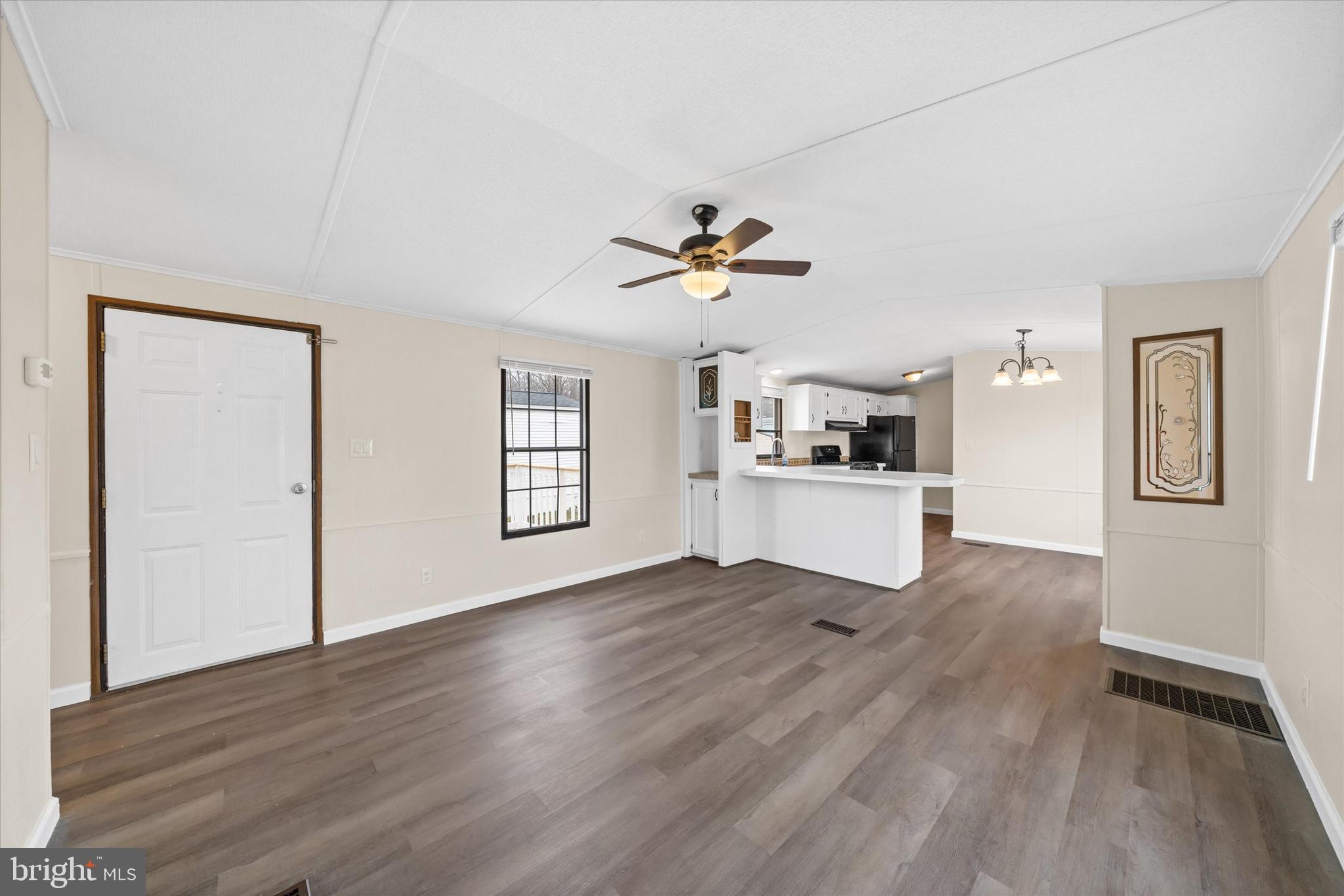 416 Ranee Loop, Unit 96 Bear, DE 19701 - Photo 6 of 31 a view of a kitchen with wooden floor and a ceiling fan