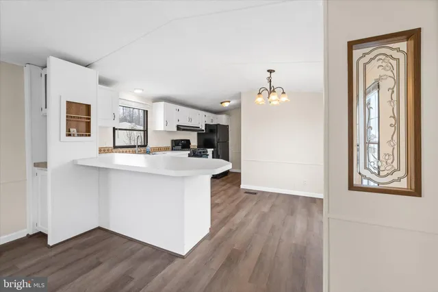 a view of kitchen with sink and wooden floor