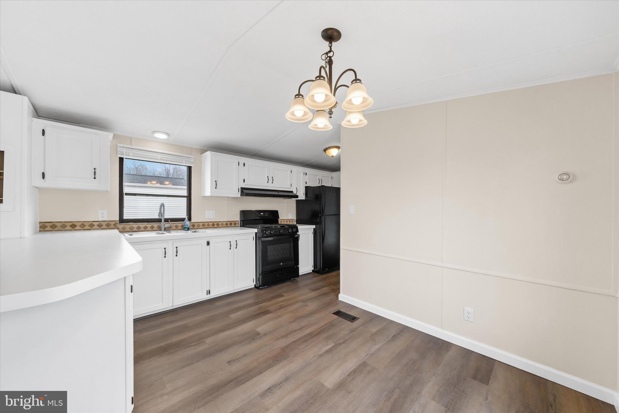 416 Ranee Loop, Unit 96 Bear, DE 19701 - Photo 9 of 31 a kitchen with a refrigerator and white cabinets