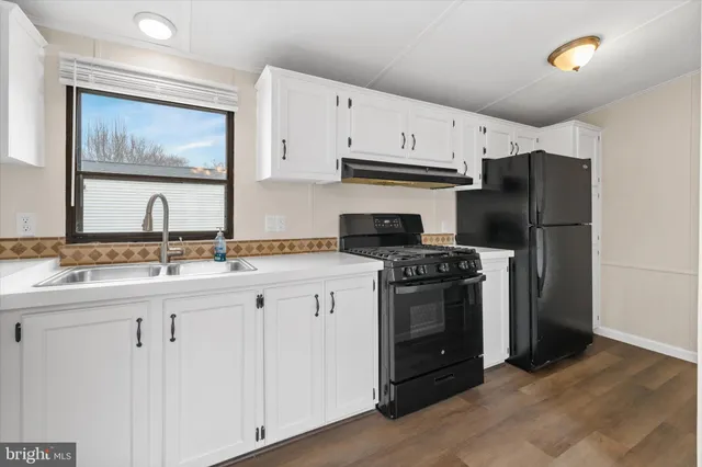 a kitchen with stainless steel appliances a stove a refrigerator and a sink