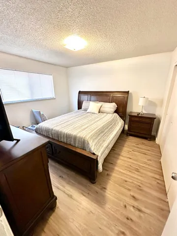 a bedroom with a bed and a night stand