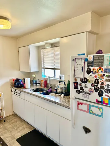 a kitchen with sink cabinets and window