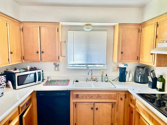 a kitchen with a sink stove top oven and cabinets