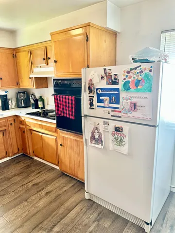 a kitchen with stainless steel appliances a stove a sink and a refrigerator