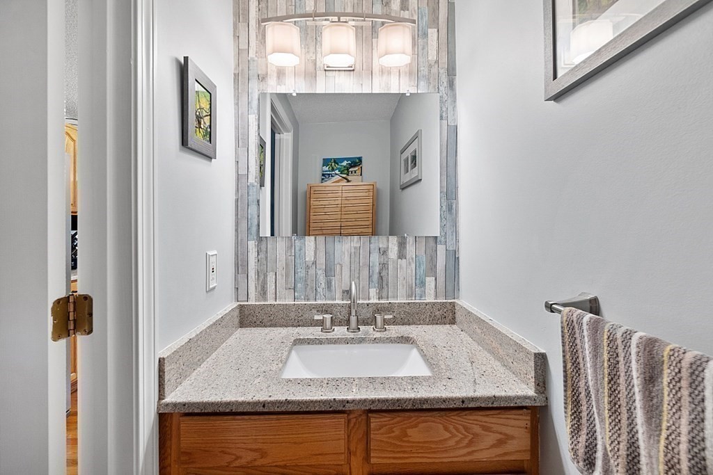 55 Littleton Road, Unit 2F Ayer, MA 01432 - Photo 12 of 29 a bathroom with a granite countertop sink and a mirror