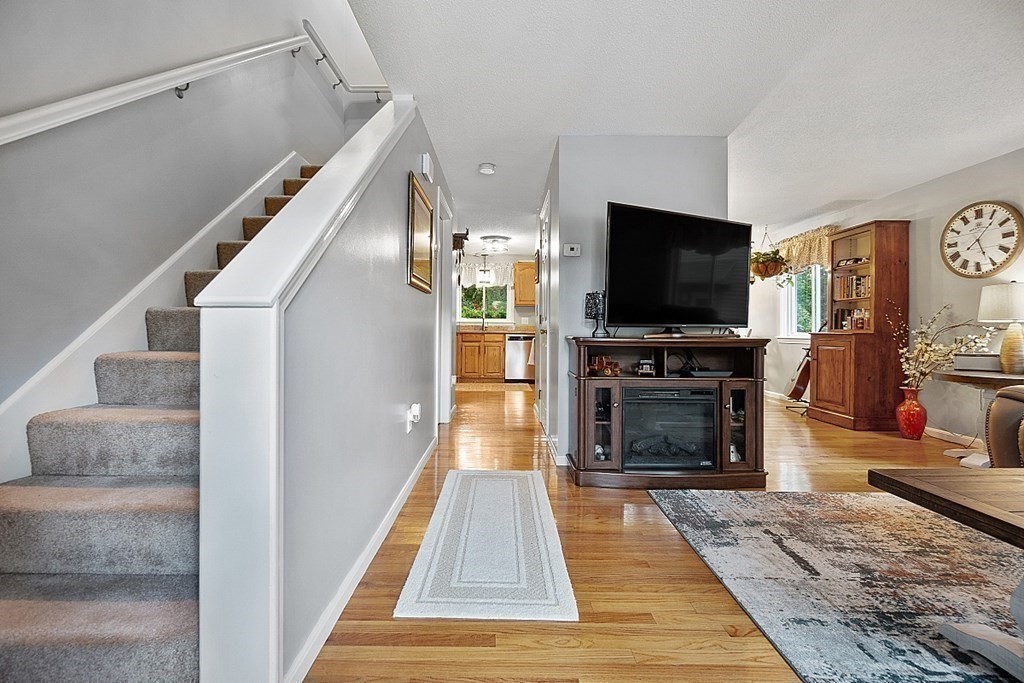 55 Littleton Road, Unit 2F Ayer, MA 01432 - Photo 13 of 29 a living room with fireplace and a flat screen tv