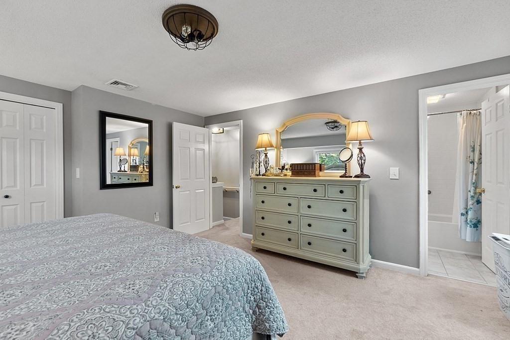 55 Littleton Road, Unit 2F Ayer, MA 01432 - Photo 16 of 29 a bedroom with a bed and a dresser in it