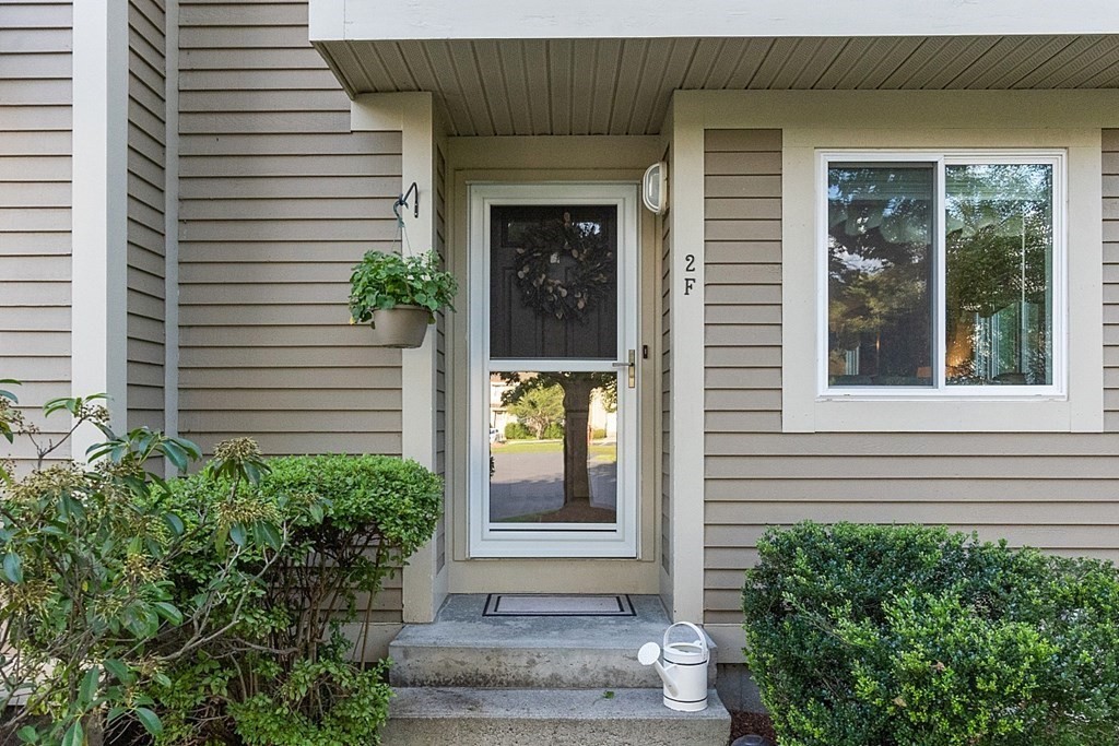 55 Littleton Road, Unit 2F Ayer, MA 01432 - Photo 2 of 29 a front view of a house with a yard